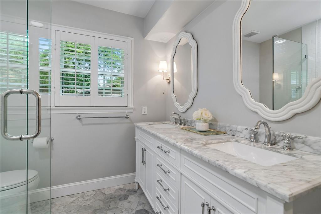 11439 Rosser Road Dallas, TX 75229 - Photo 18 of 35 a bathroom with a granite countertop sink a mirror and a shower