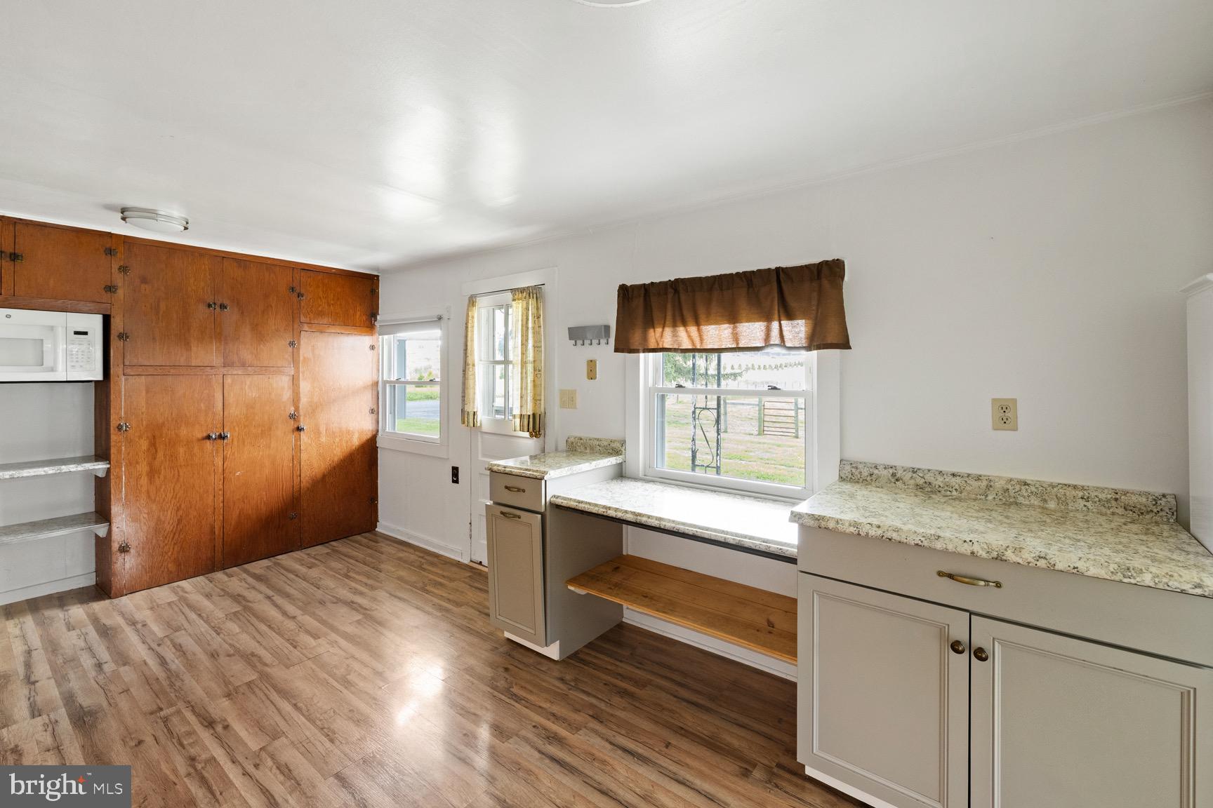 1275 Georgetown Road Mount Jackson, VA 22842 - Photo 19 of 45 a kitchen with a wooden floor and cabinets