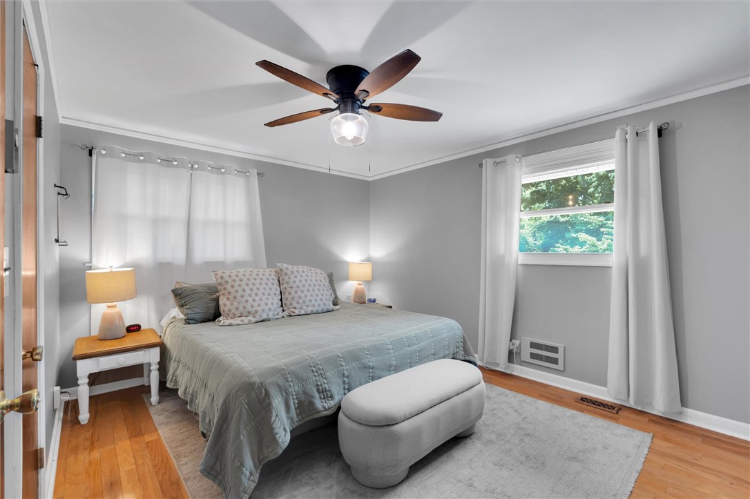 1815 Pearman Dairy Road Anderson, SC 29625 - Photo 15 of 35 Hardwood floors and ample natural light define this cozy and comfortable bedroom retreat.