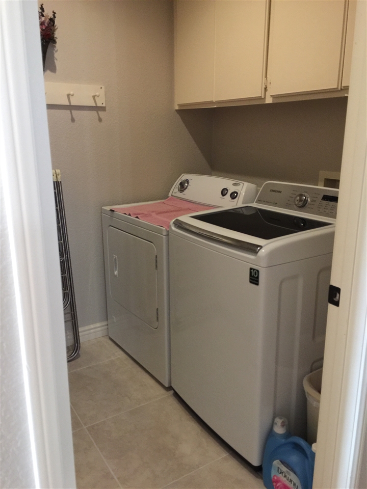 7591 Windy Ridge Road San Diego, CA 92126 - Photo 10 of 25 Laundry room on first floor next to garage entrance.