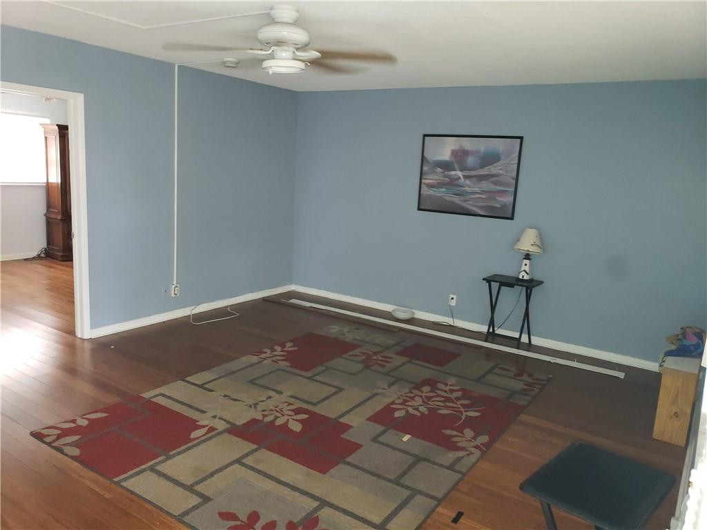 3212 Colony Club Road, Unit 2 Pompano Beach, FL 33062 - Photo 3 of 9 a view of a room with wooden floor and ceiling fan