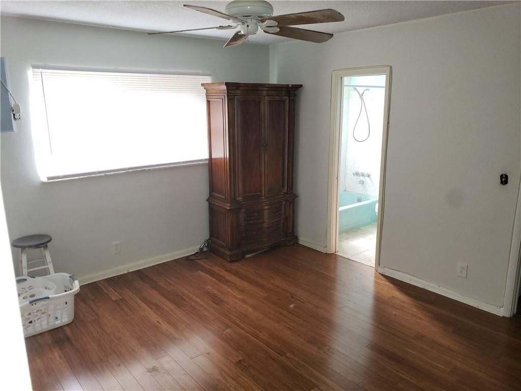 3212 Colony Club Road, Unit 2 Pompano Beach, FL 33062 - Photo 5 of 9 a view of an empty room with wooden floor and a window