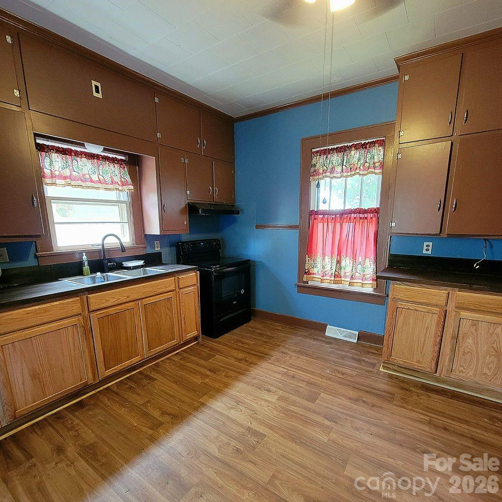 109 Ridge Avenue Salisbury, NC 28144 - Photo 11 of 20 a kitchen with stainless steel appliances granite countertop a sink window and cabinets