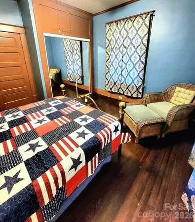 a bedroom with two beds and a window