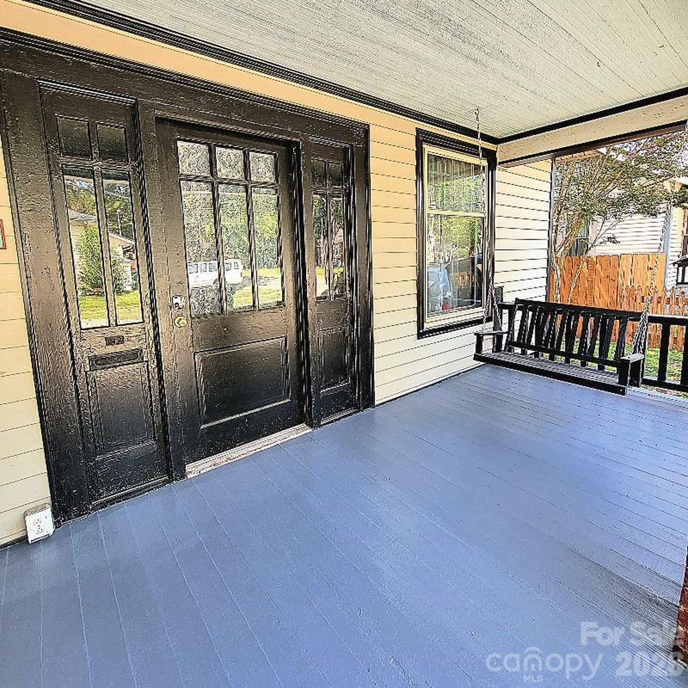 109 Ridge Avenue Salisbury, NC 28144 - Photo 3 of 20 an empty room with wooden floor and windows