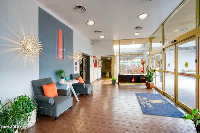 a lobby with furniture and a potted plant