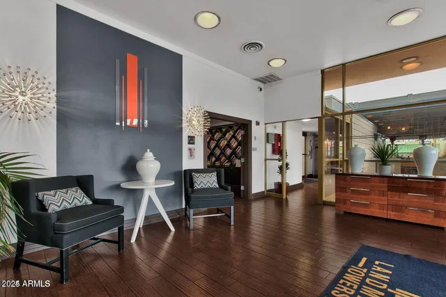 a living room with furniture and a wooden floor