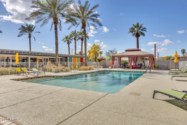a view of a house with pool and sitting area
