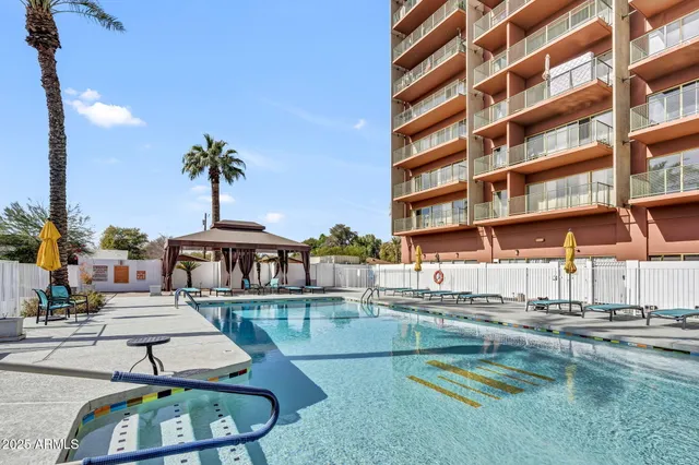 a swimming pool with outdoor seating and yard