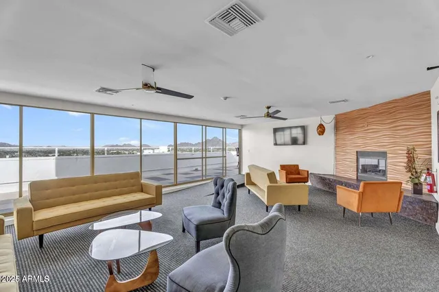 a living room with furniture and a floor to ceiling window