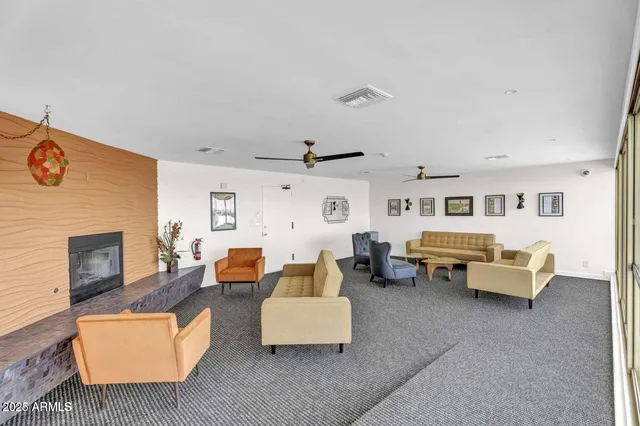 a living room with furniture and a fireplace