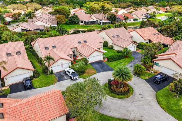 an aerial view of a house with garden space and a houses