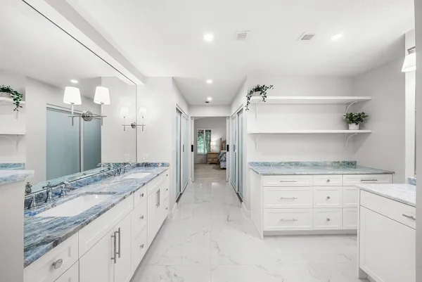 a white bath tub sitting next to a shower