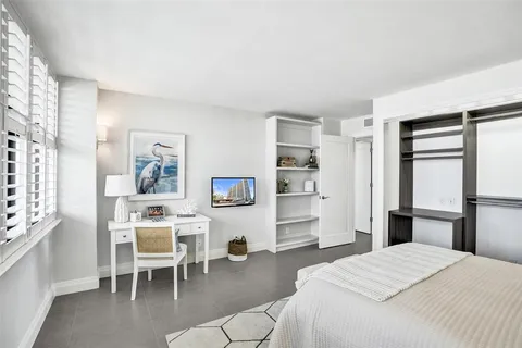 a bathroom with a granite countertop sink toilet a large mirror a bathtub and shower