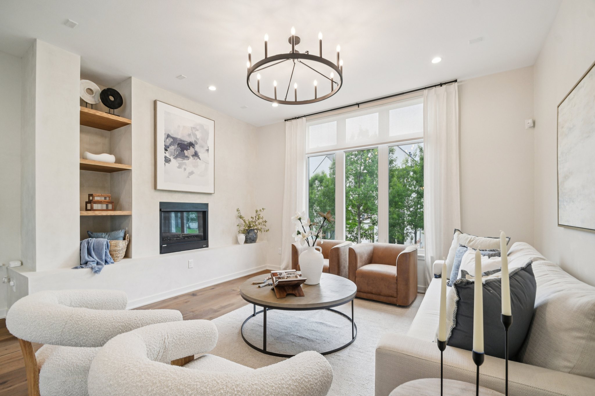 a living room with furniture a fireplace and a large window
