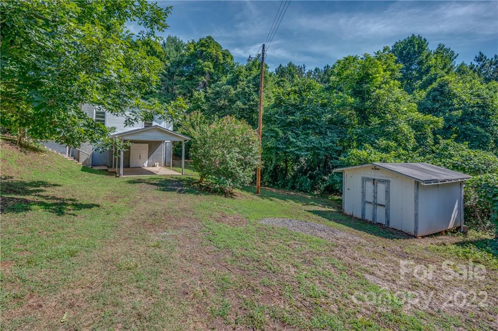 4580 Hudlow Road Rutherfordton, NC 28139 - Photo 4 of 32 a backyard of a house with wooden fence and large trees