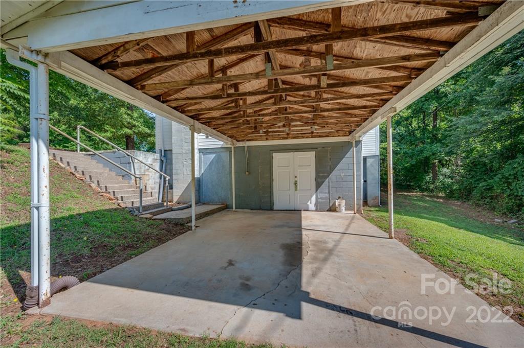 4580 Hudlow Road Rutherfordton, NC 28139 - Photo 8 of 32 a patio with a table and chairs and a barbeque