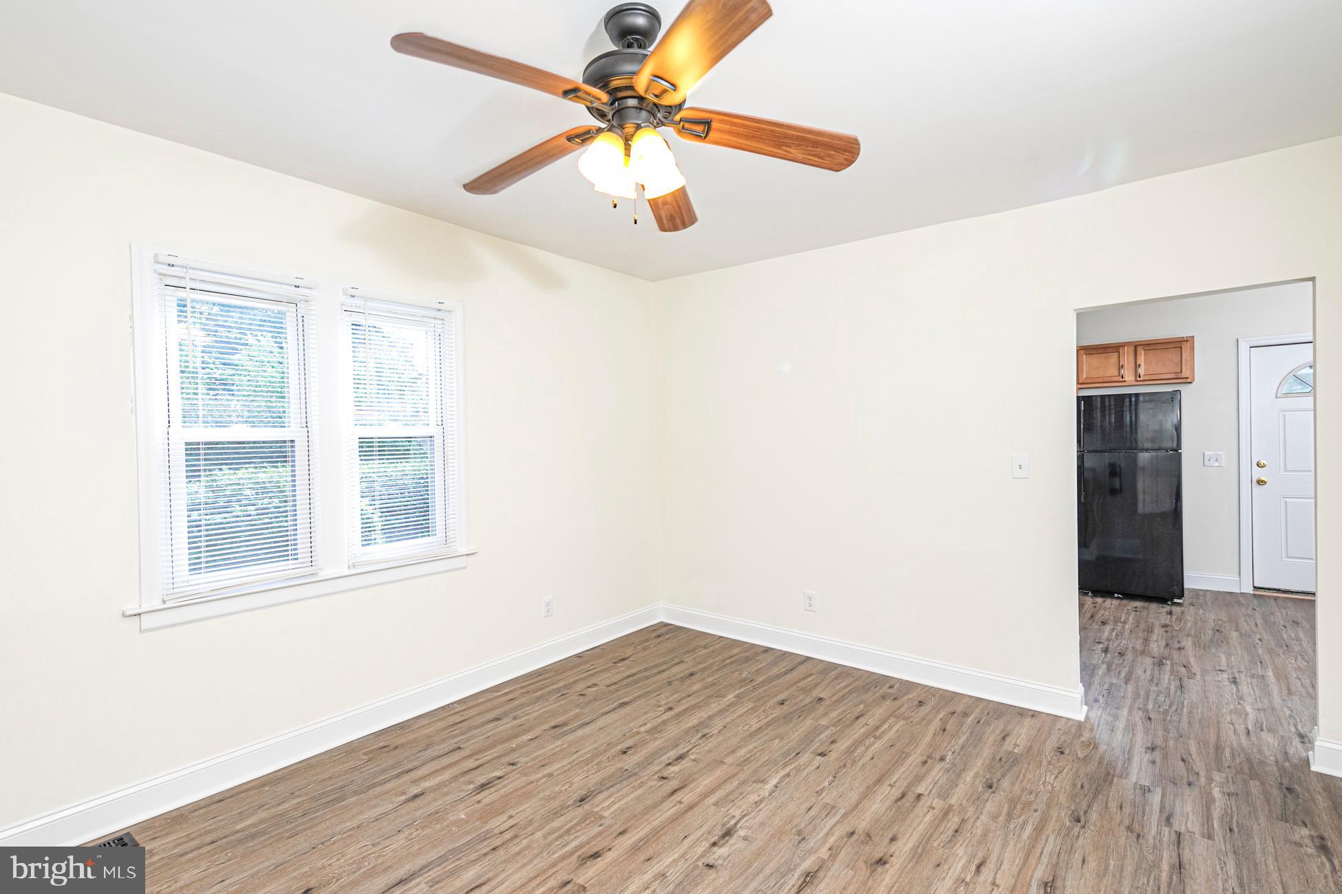 166 John Street Princeton, NJ 08540 - Photo 12 of 29 an empty room with wooden floor chandelier fan and windows