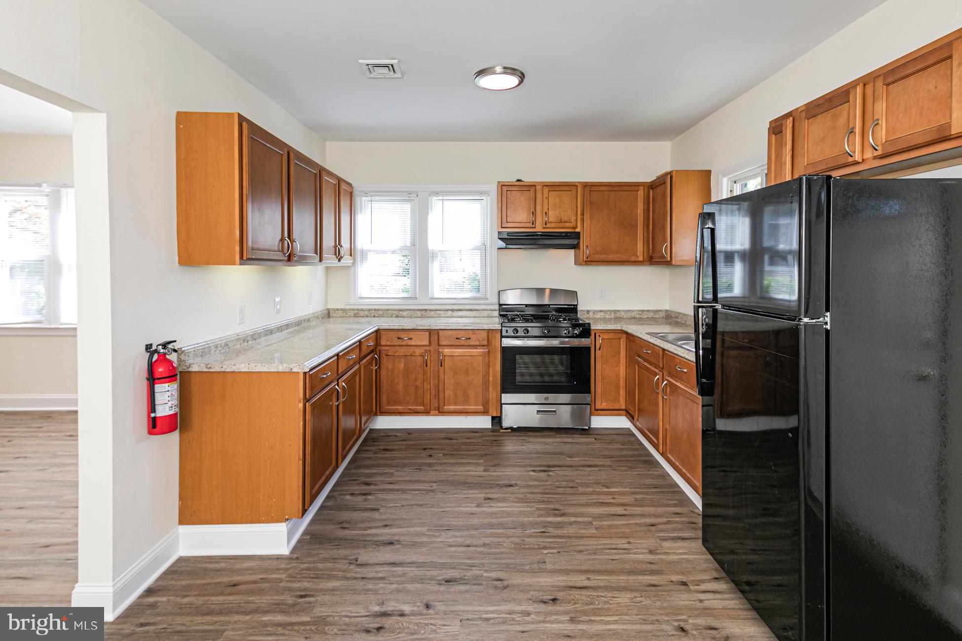 166 John Street Princeton, NJ 08540 - Photo 7 of 29 a large kitchen with stainless steel appliances granite countertop a stove top oven a sink dishwasher and a refrigerator
