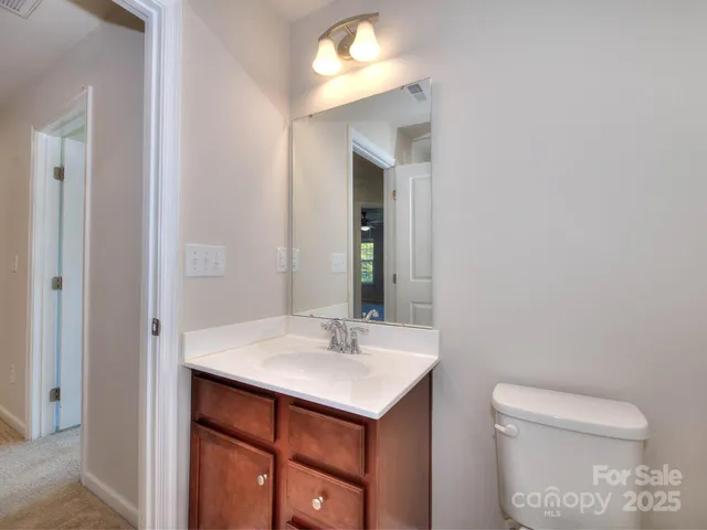 a bathroom with a sink toilet and mirror