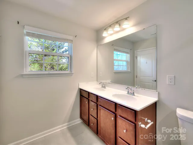 a bathroom with a sink double vanity and a mirror