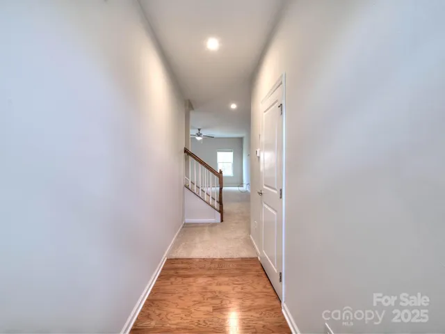 a view of a hallway with wooden floor