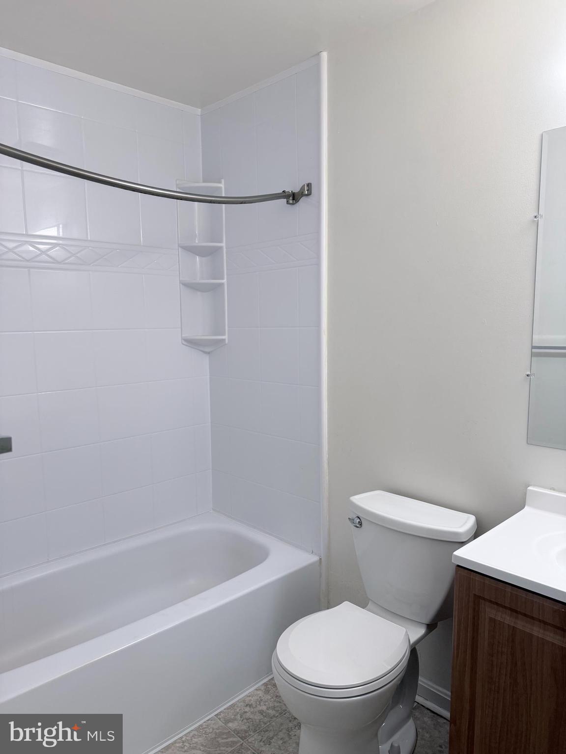 8573 Ritchboro Road District Heights, MD 20747 - Photo 11 of 19 a white toilet sitting next to a bath tub and a shower