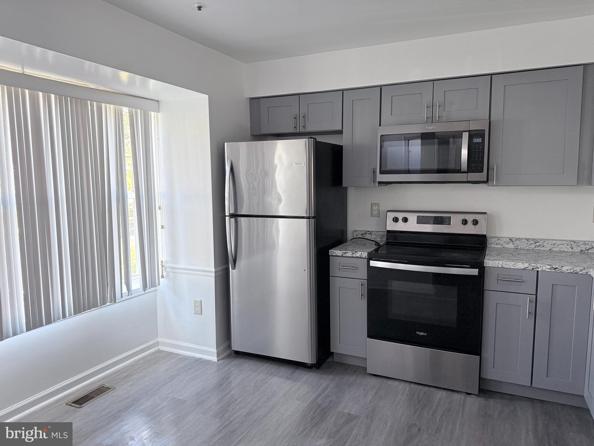 8573 Ritchboro Road District Heights, MD 20747 - Photo 3 of 19 a kitchen with a refrigerator sink and microwave
