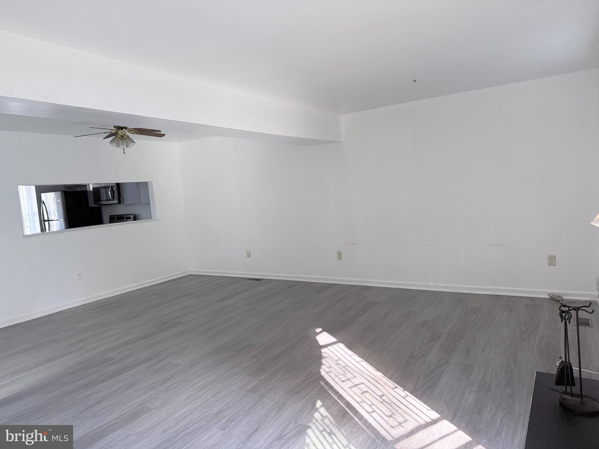 8573 Ritchboro Road District Heights, MD 20747 - Photo 4 of 19 an empty room with wooden floor and windows