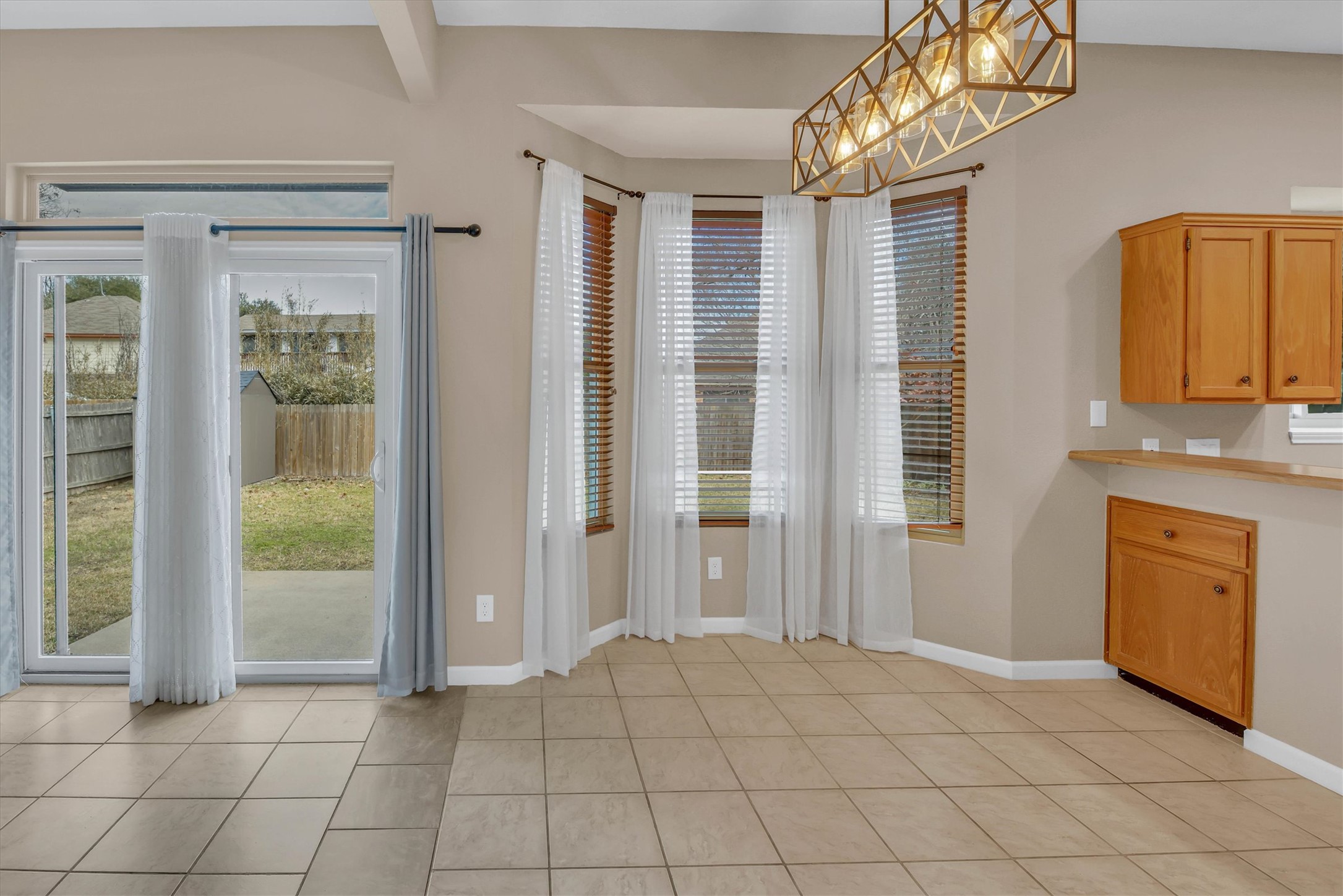 8108 Matchlock Cove Austin, TX 78729 - Photo 14 of 40 Doorway to outside with baseboards and tile patterned floors