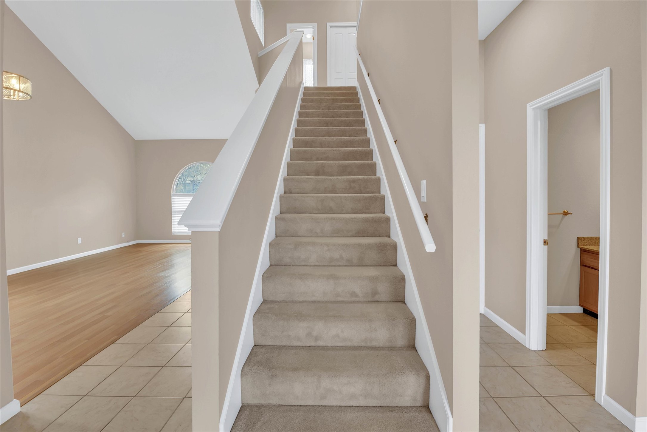 8108 Matchlock Cove Austin, TX 78729 - Photo 19 of 40 Stairway featuring tile patterned floors and a high ceiling