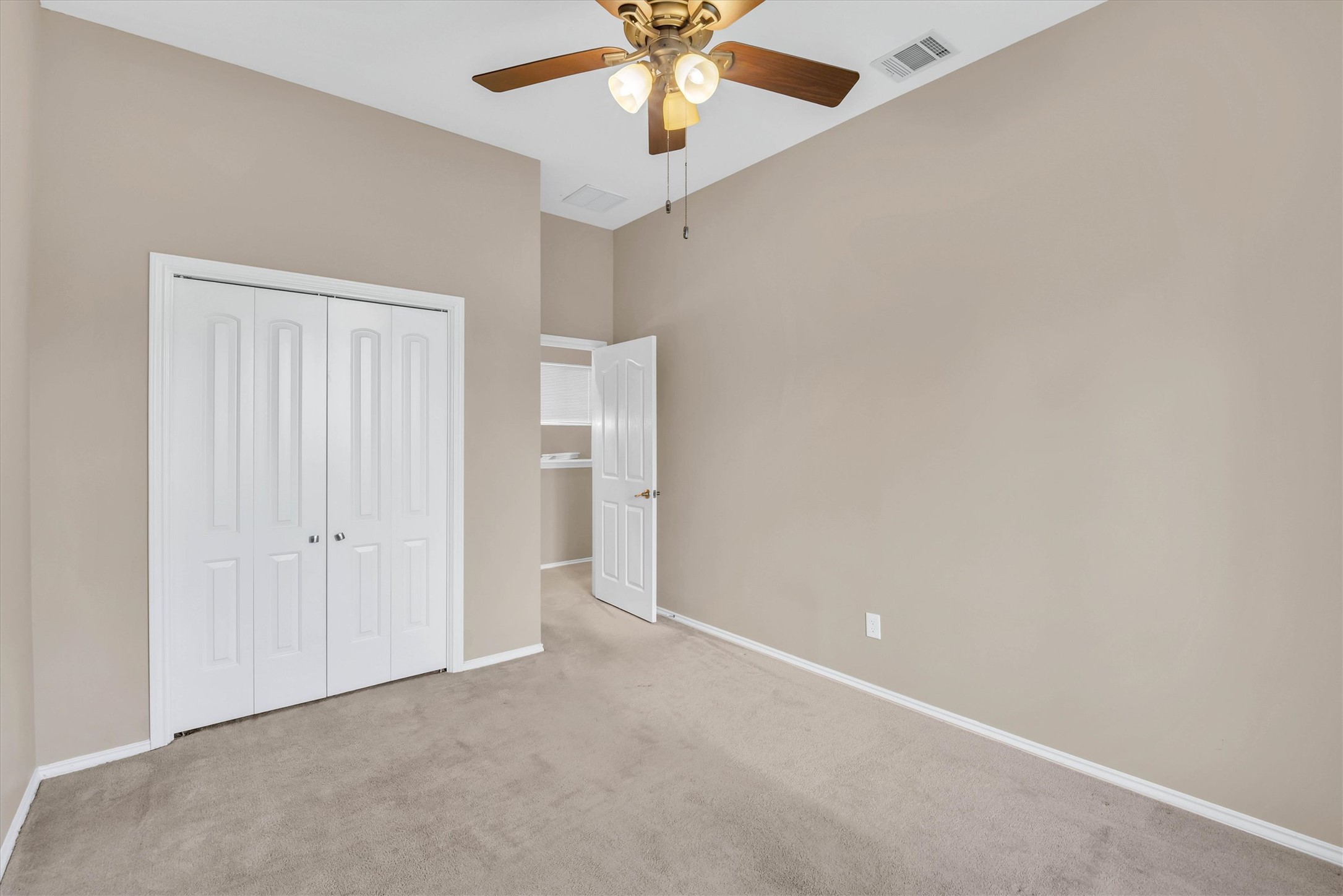 8108 Matchlock Cove Austin, TX 78729 - Photo 21 of 40 Unfurnished bedroom featuring carpet flooring, a ceiling fan, and a closet
