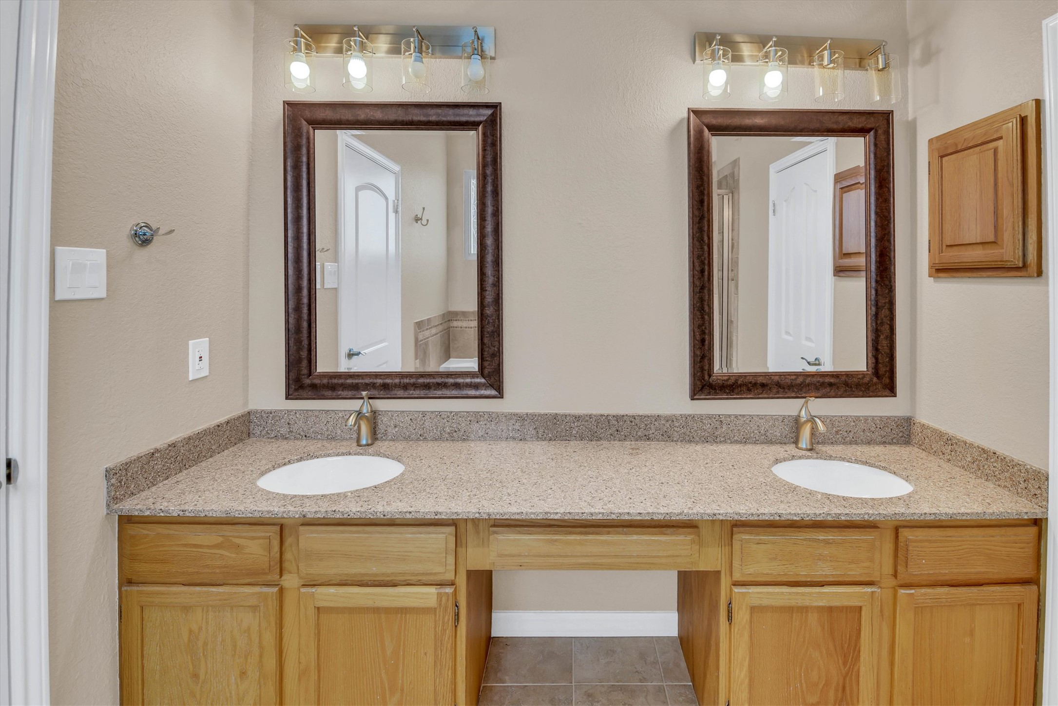 8108 Matchlock Cove Austin, TX 78729 - Photo 31 of 40 Bathroom with double vanity and light tile patterned floors