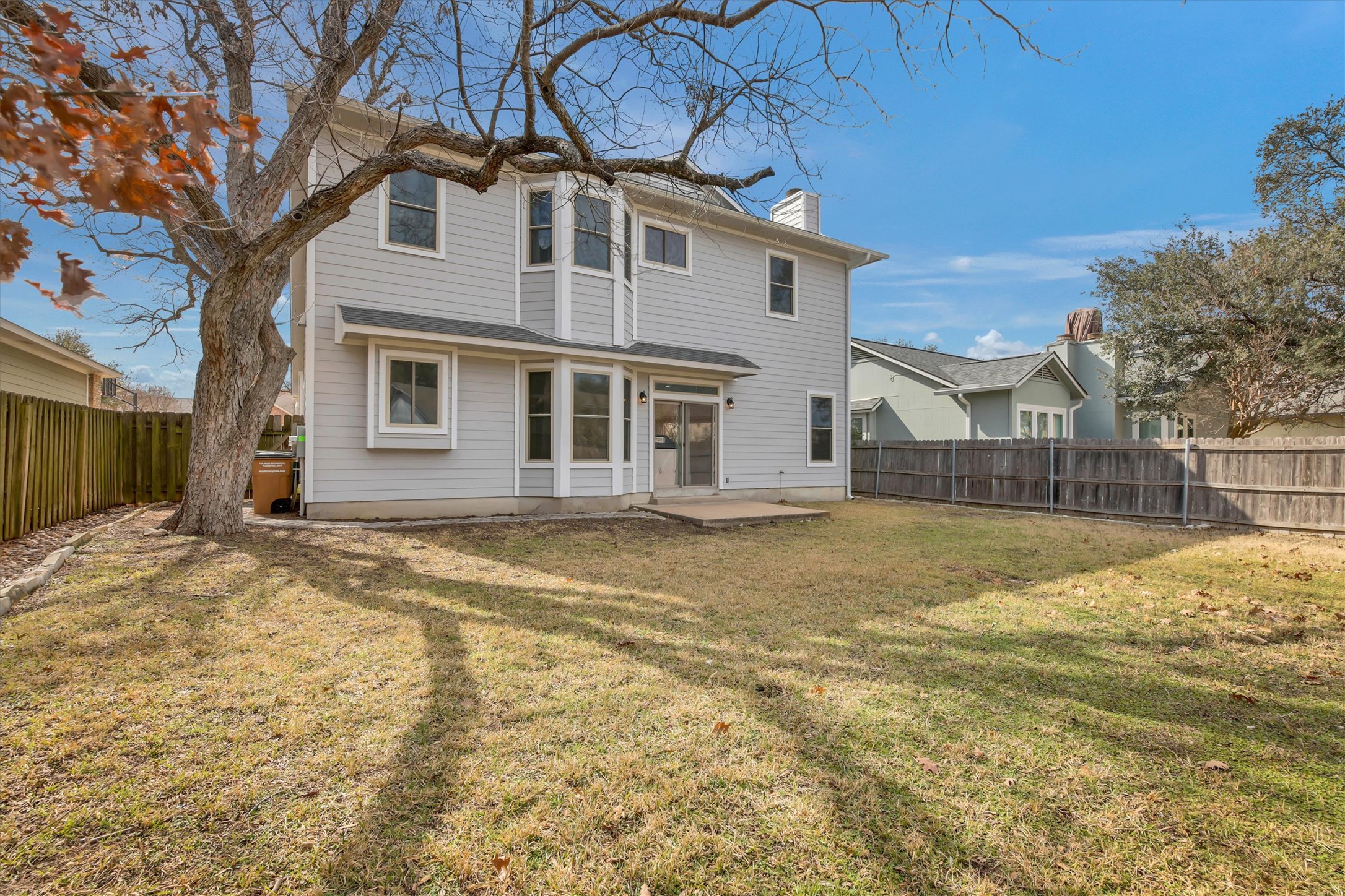 8108 Matchlock Cove Austin, TX 78729 - Photo 4 of 40 Back of property featuring a fenced backyard and a chimney