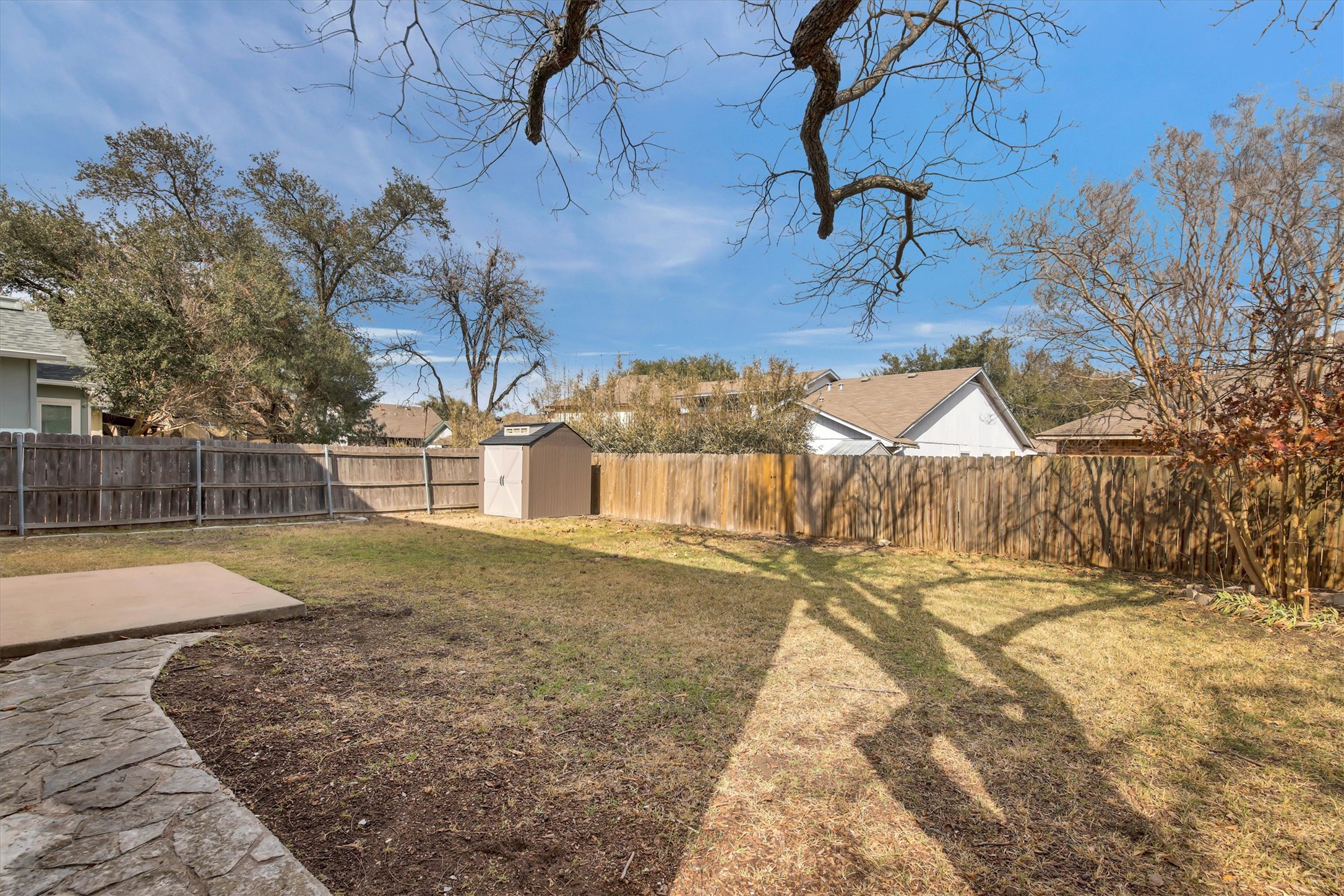 8108 Matchlock Cove Austin, TX 78729 - Photo 5 of 40 Fenced backyard with a storage shed