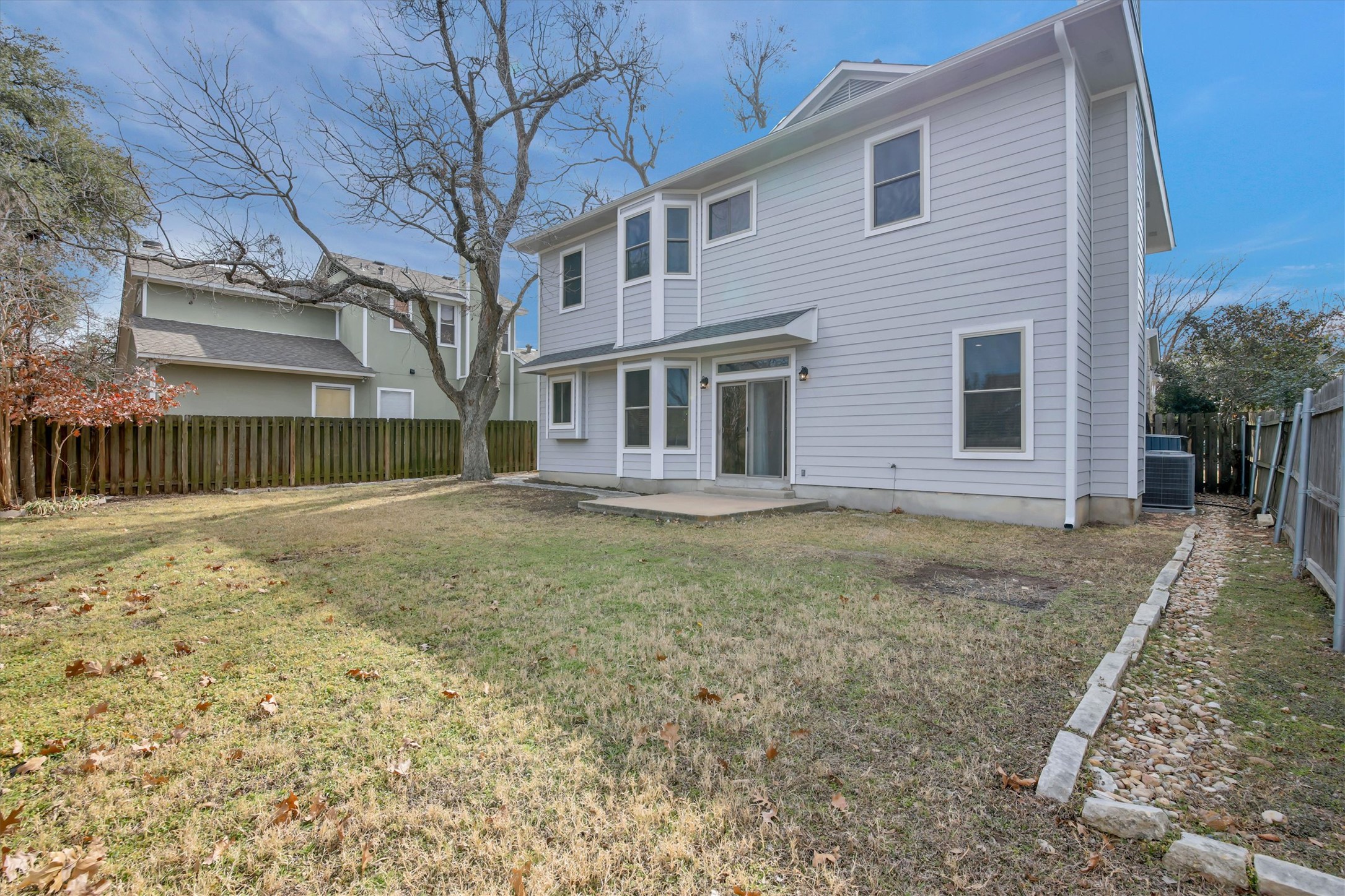 8108 Matchlock Cove Austin, TX 78729 - Photo 6 of 40 Rear view of house with a fenced backyard and a patio