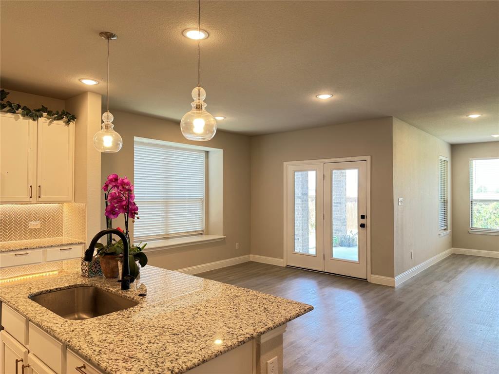 7308 Roaring Springs Road Arlington, TX 76002 - Photo 11 of 29 a kitchen with a sink and chandelier