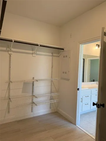 a view of walk in closet with empty racks