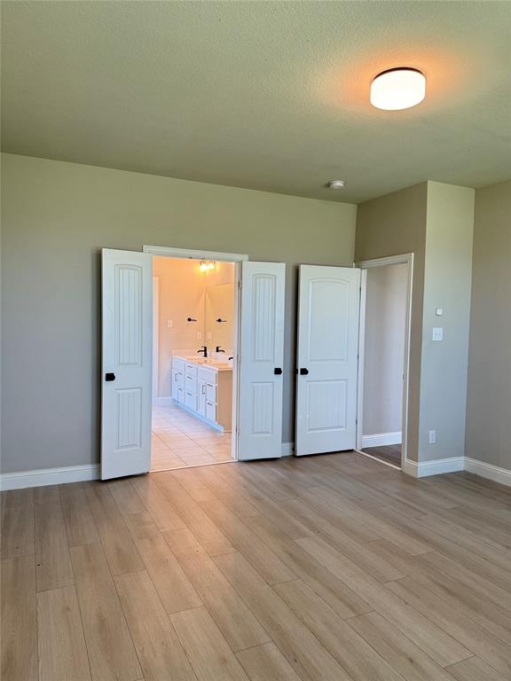 7308 Roaring Springs Road Arlington, TX 76002 - Photo 18 of 29 an empty room with wooden floor and windows
