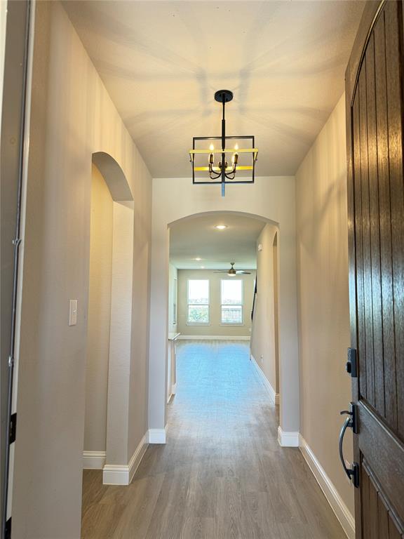 7308 Roaring Springs Road Arlington, TX 76002 - Photo 3 of 29 a view of a hallway with wooden floor and staircase