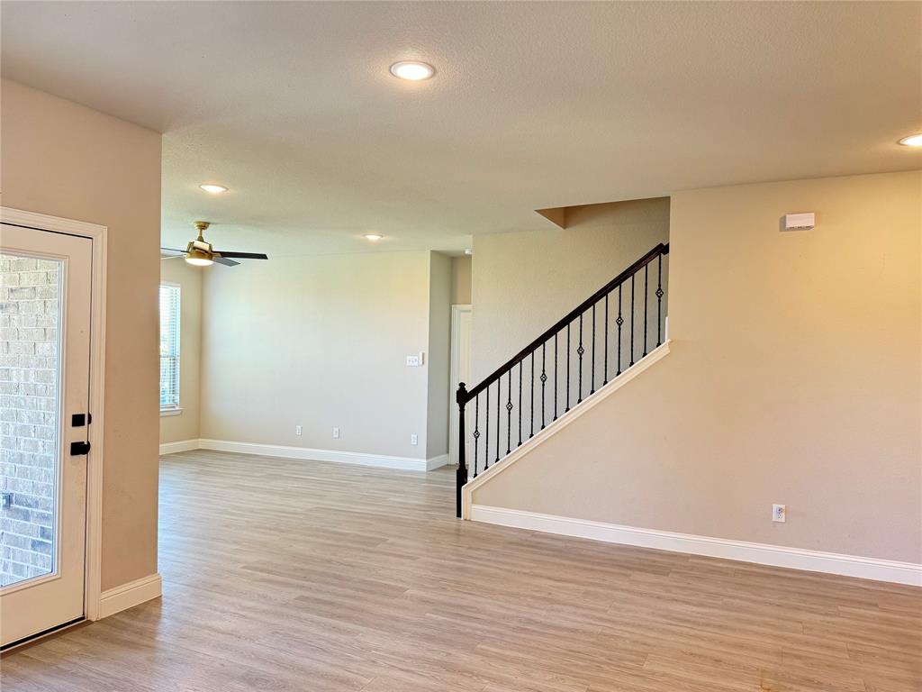 7308 Roaring Springs Road Arlington, TX 76002 - Photo 5 of 29 wooden floor in an empty room with a window