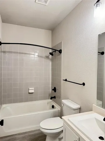 a bathroom with a toilet a sink and a bathtub