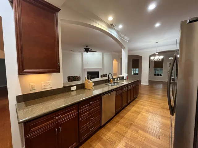 a large kitchen with a large counter top appliances and cabinets