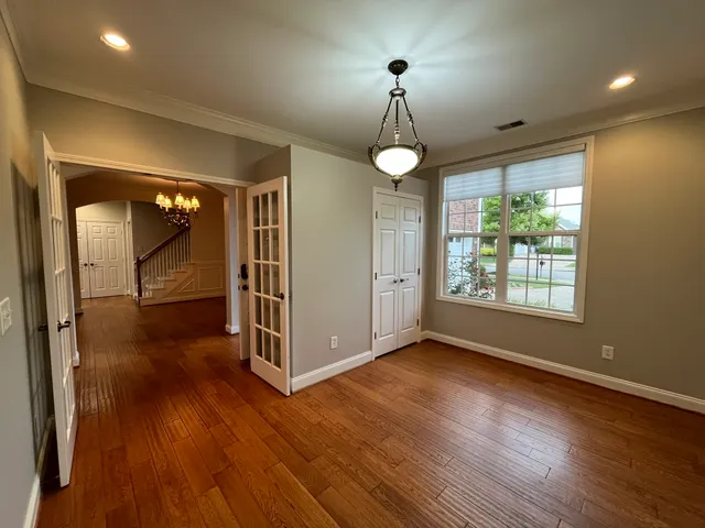 a view of a livingroom with wooden floor and window