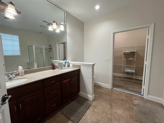 a bathroom with a sink vanity and mirror