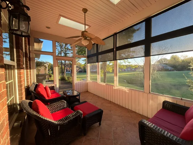 a view of a porch with furniture and a gate