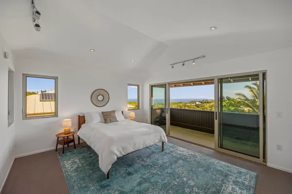 a bedroom with a bed and a large window