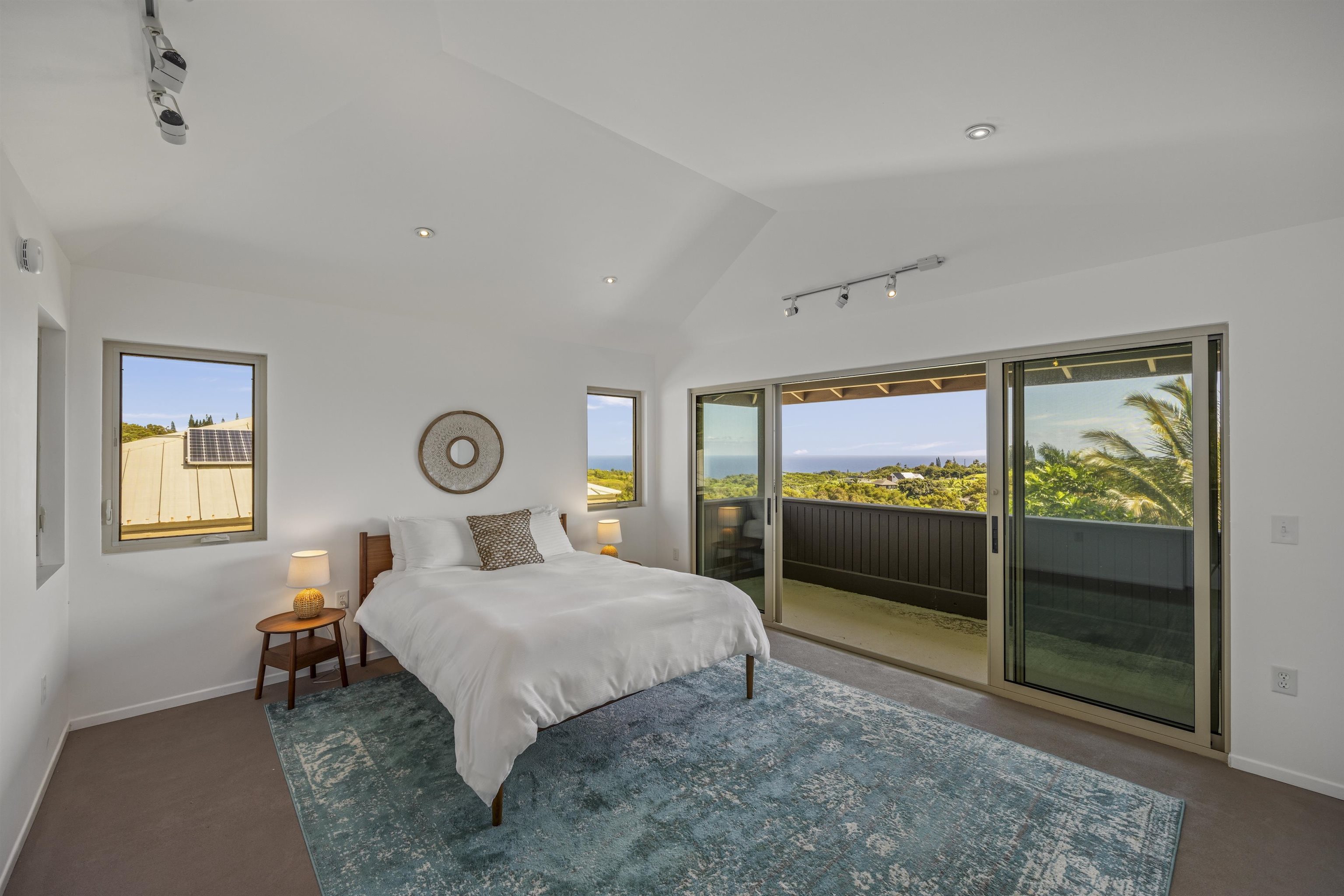 41 Leleaka Place, Unit A Haiku, HI 96708 - Photo 26 of 40 a bedroom with a bed and a large window