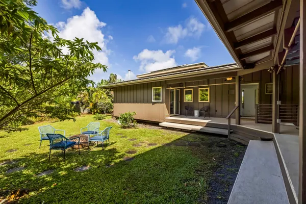 a view of a house with backyard sitting area and garden