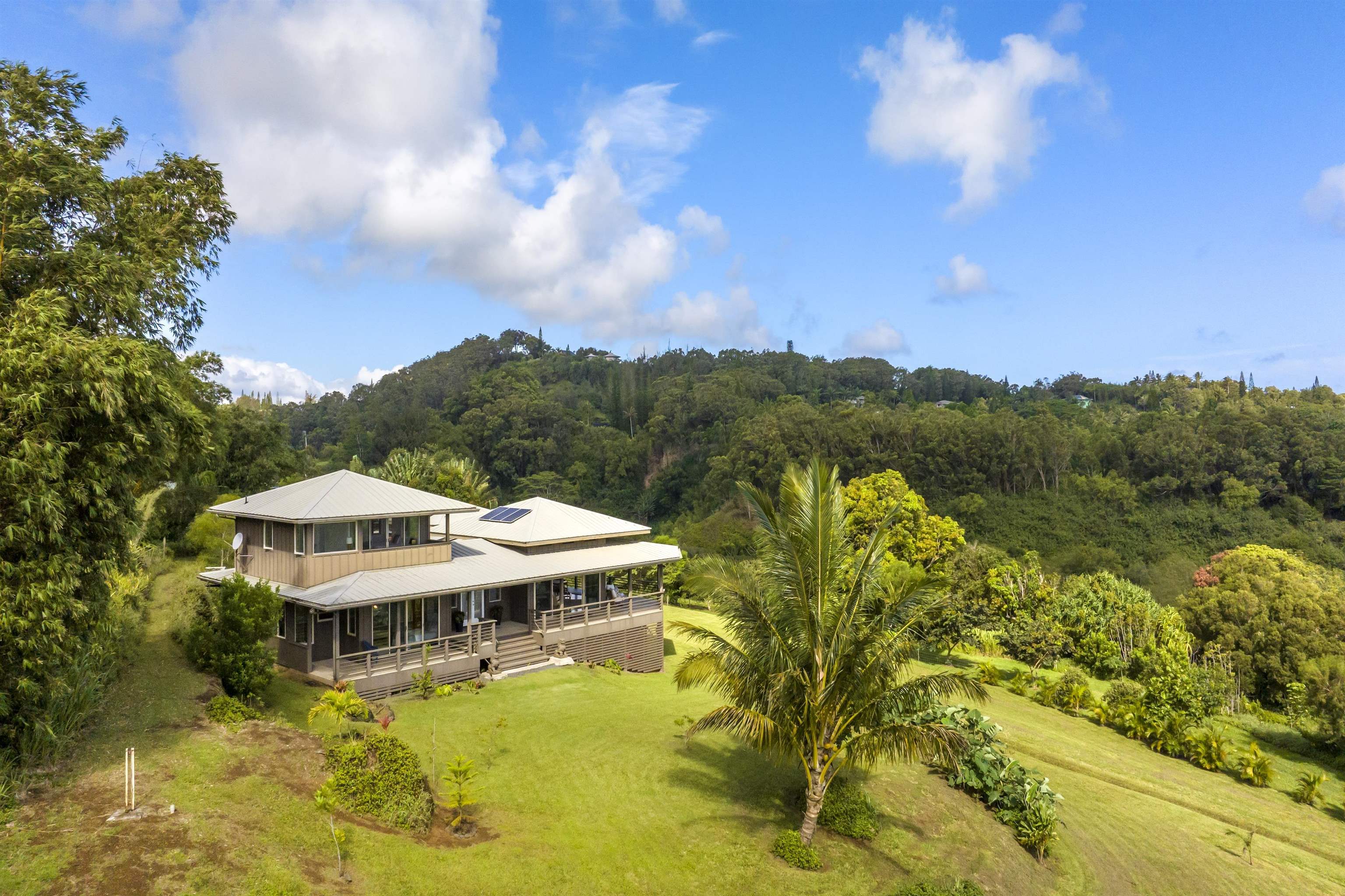 41 Leleaka Place, Unit A Haiku, HI 96708 - Photo 3 of 40 a view of a lake with a house in the background